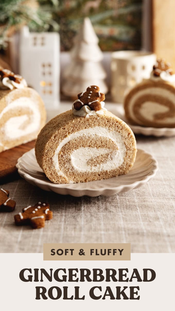 A slice of gingerbread roll cake on a plate with a gingerbread man cookie on top.