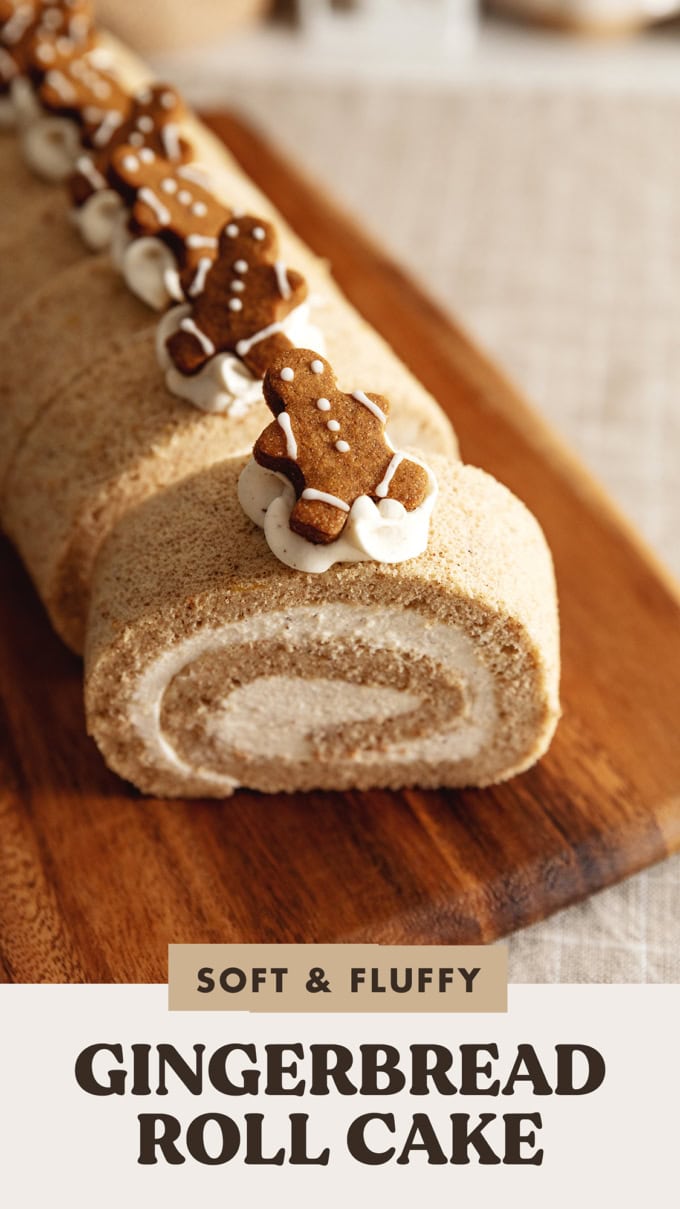 Close up of a gingerbread man cookie on top of a slice of gingerbread roll cake.