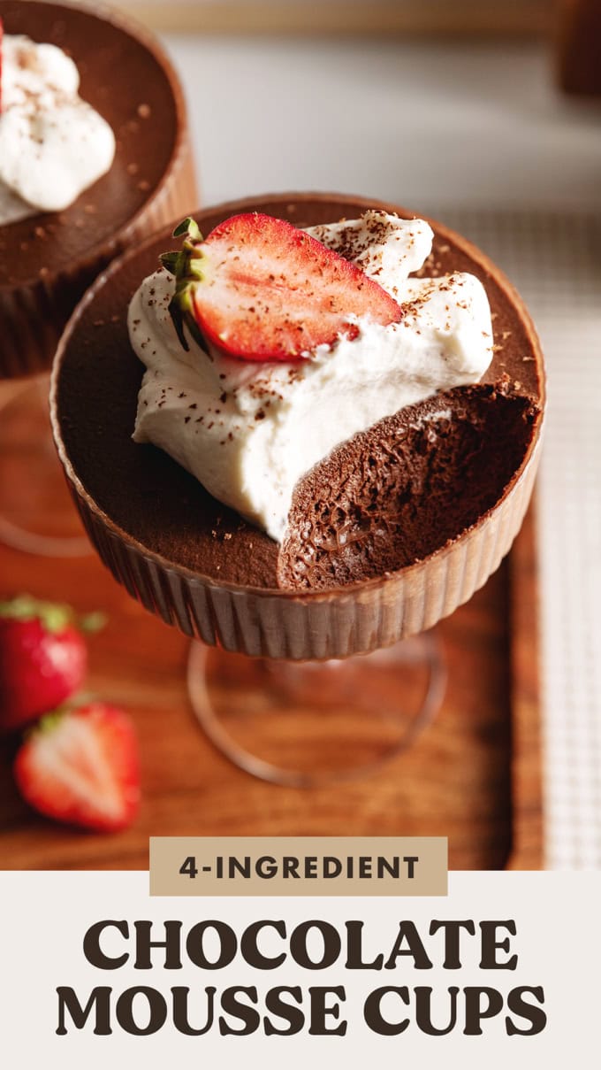 A chocolate mousse cup with a spoonful scooped out of the cup to show the texture inside.